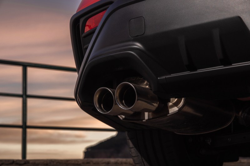 2024 Subaru WRX TR left rear view shot below the bumper focused on the split dual exhaust tips on left side.