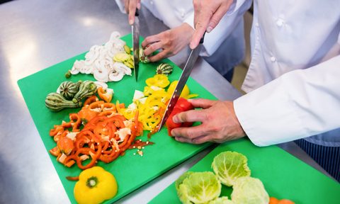 Hands chopping vegetables