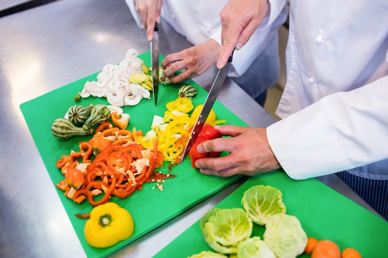 Hands chopping vegetables