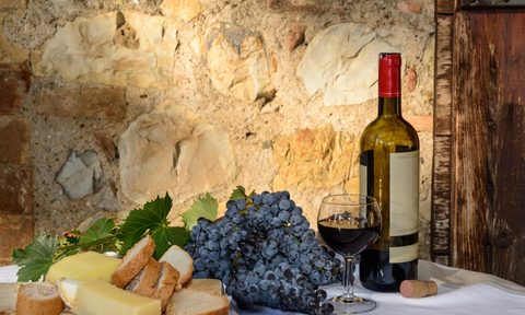 Spread of wine, cheese, and grapes