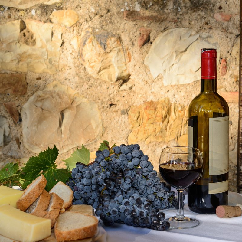 Spread of wine, cheese, and grapes