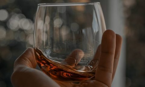 Bourbon in a glass in a hand