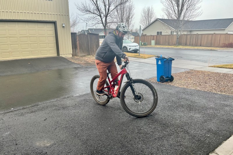 Track standing on a mountain bike in a driveway