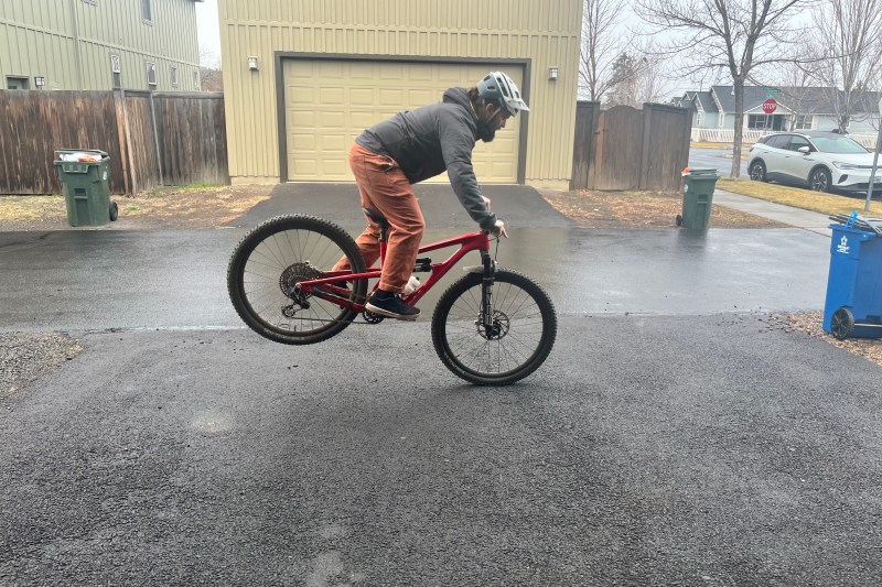 Practicing stoppies on a mountain bike in a driveway