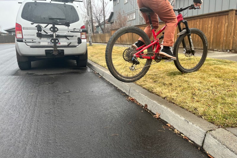 A rear-wheel lift on a mountain bike up a curb