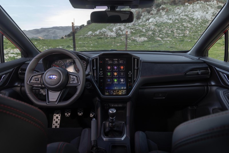 2024 Subaru WRX TR in red direct front view as the car drives on a mountain road