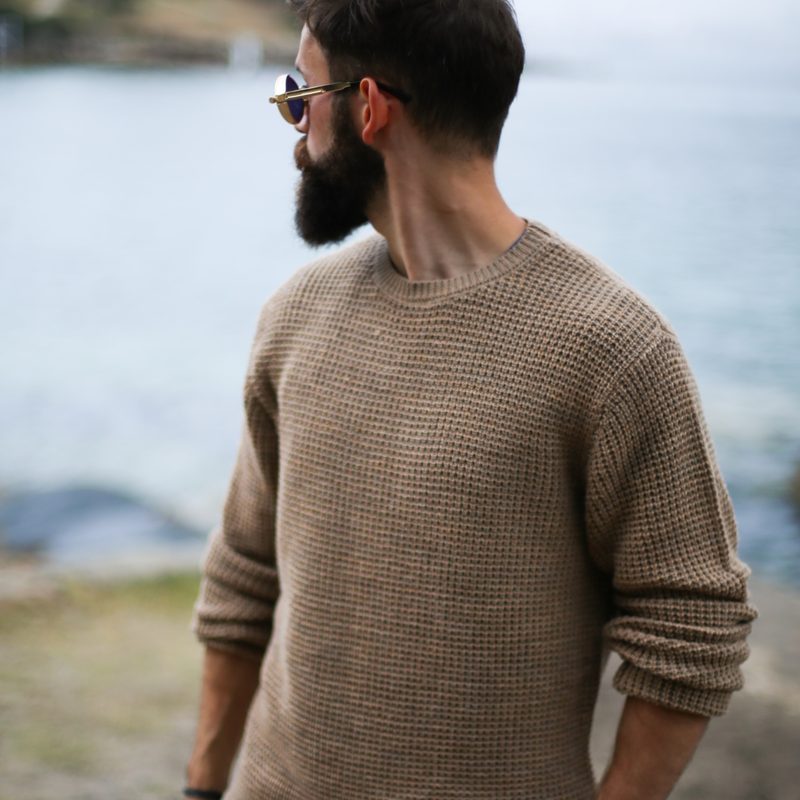 Man in sweater on the beach