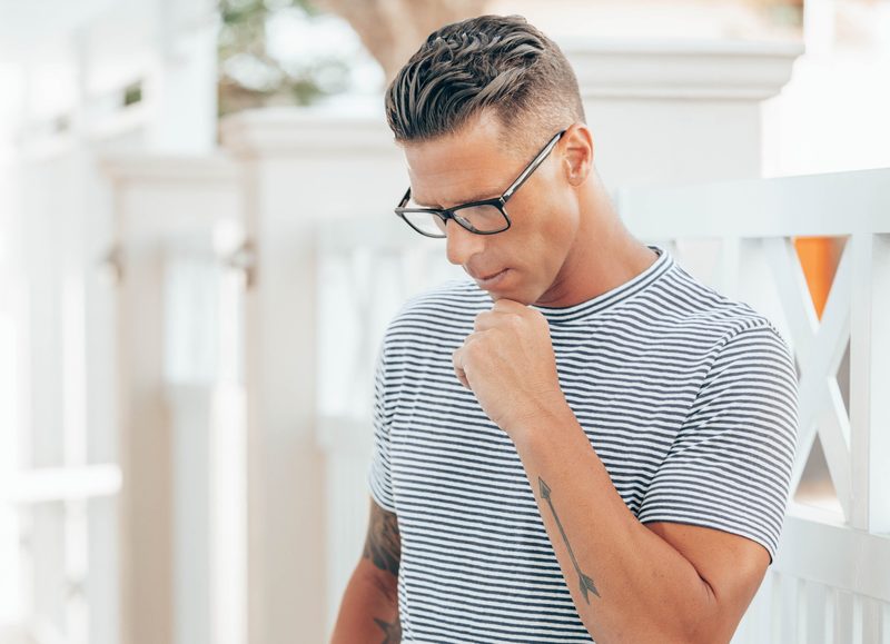 Man in tshirt wearing glasses