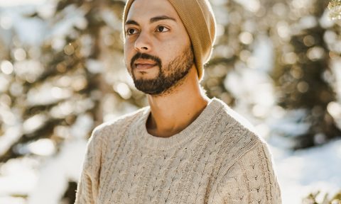 Man in woodswith sweater and beanie