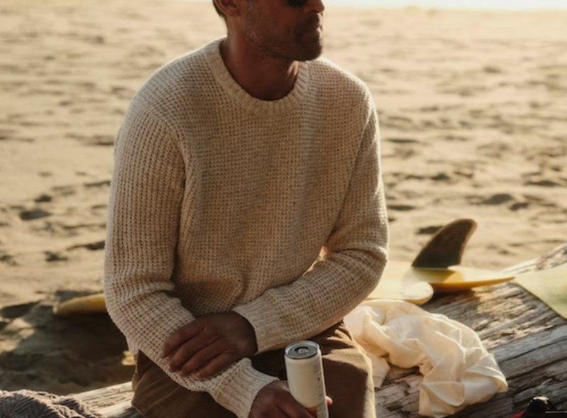 Man on beach wearing Wellen Recycled Cotton Headlands Sweater