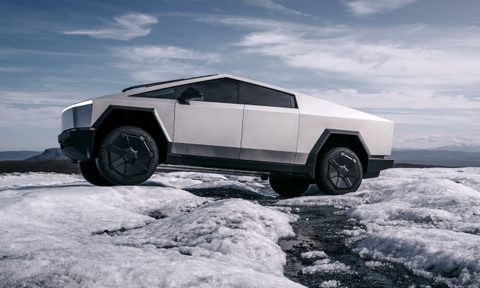 Tesla Cybertruck EV driving in snow.