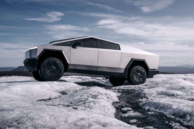 Tesla Cybertruck EV driving in snow.
