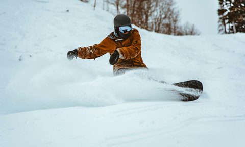 snowboarder wearing goggles in powder