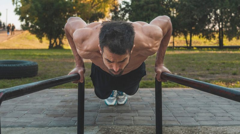 man doing calisthenics workout outside