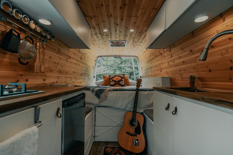 The cramped living quarters of a conversion van.