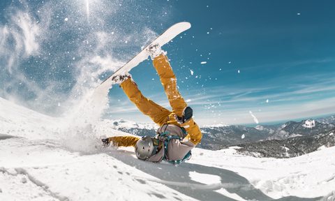 Real snowboarder falls at offpiste ski slope. ski safety concept