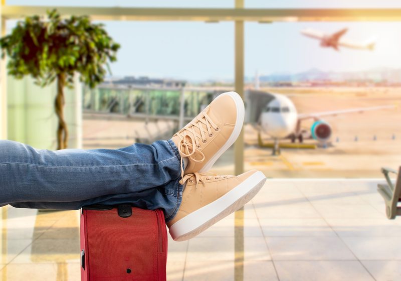 Close-up of young man waiting for the plane at an airport