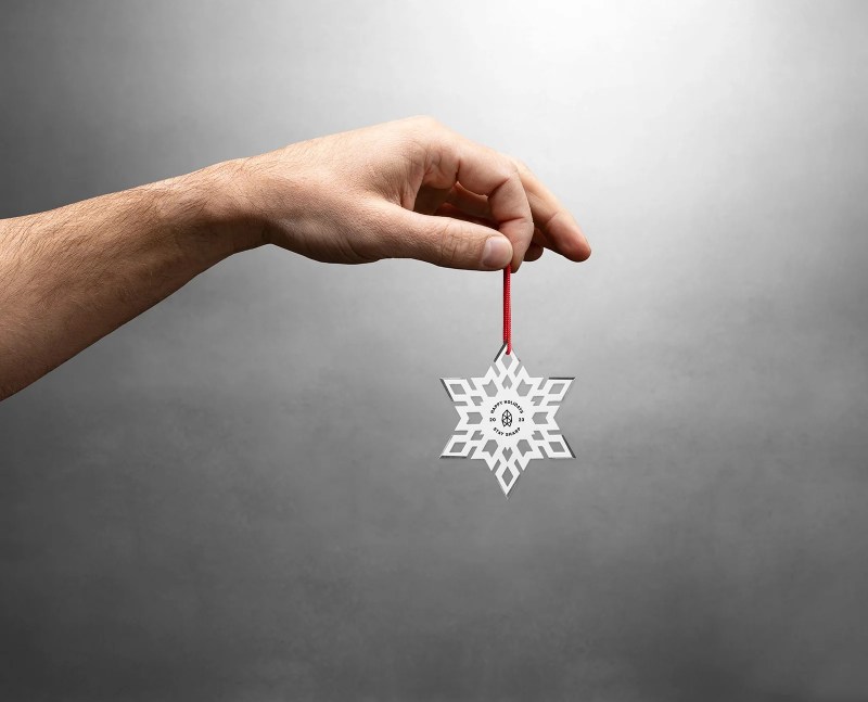 Someone holding up the Throwflake tree ornament.