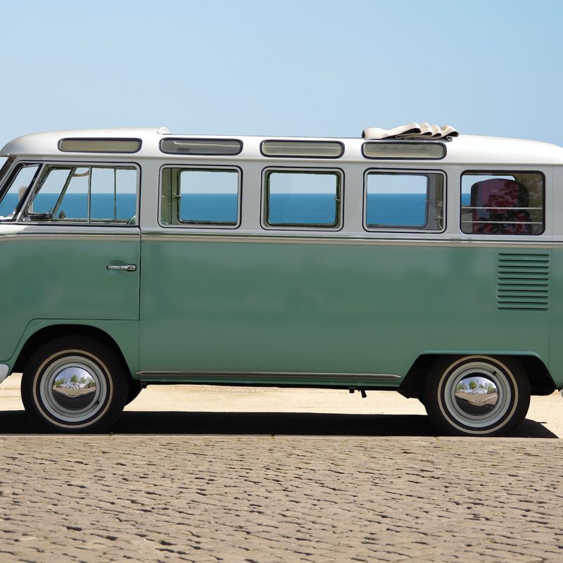 Blue camper van parked at the coast