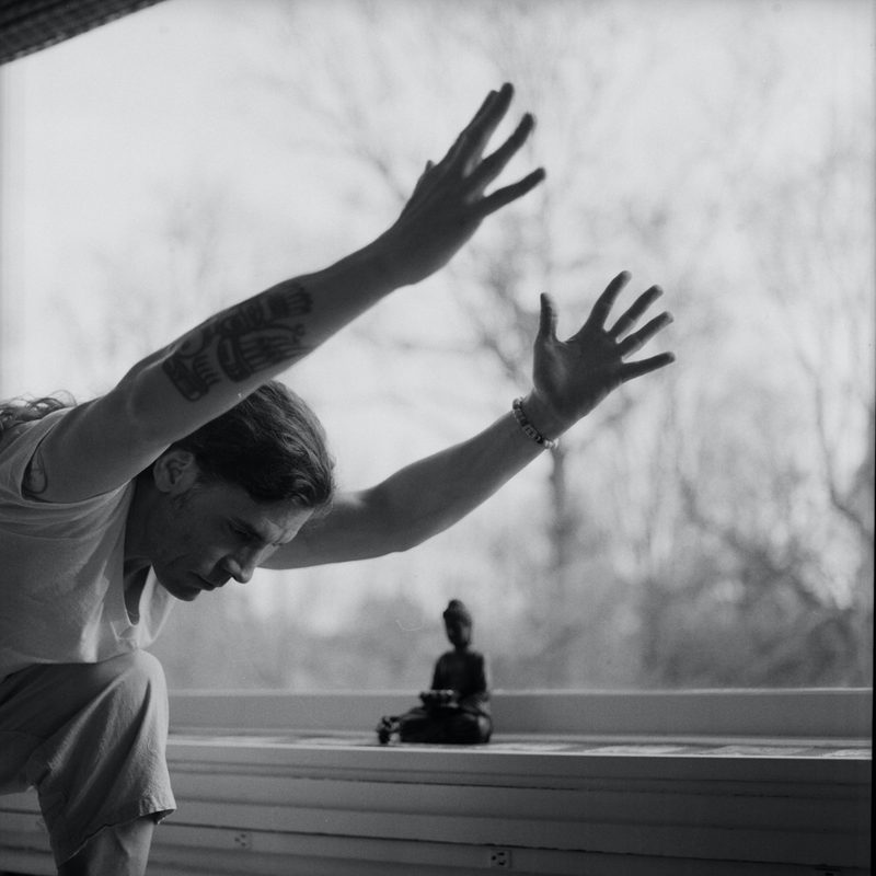 man doing yoga arms in front