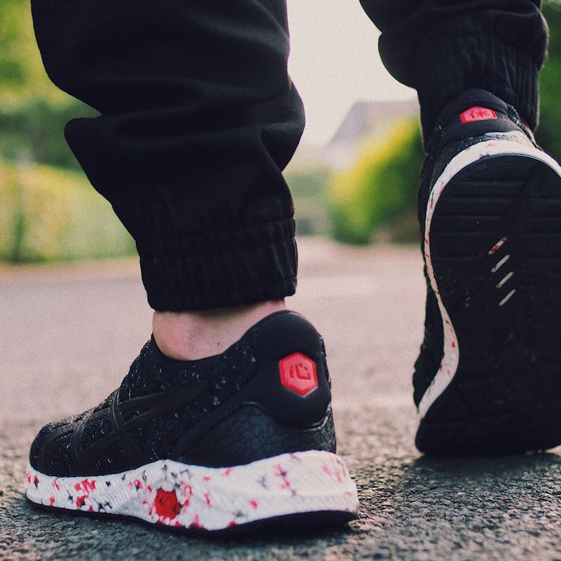 Person in black sneakers walking on the street