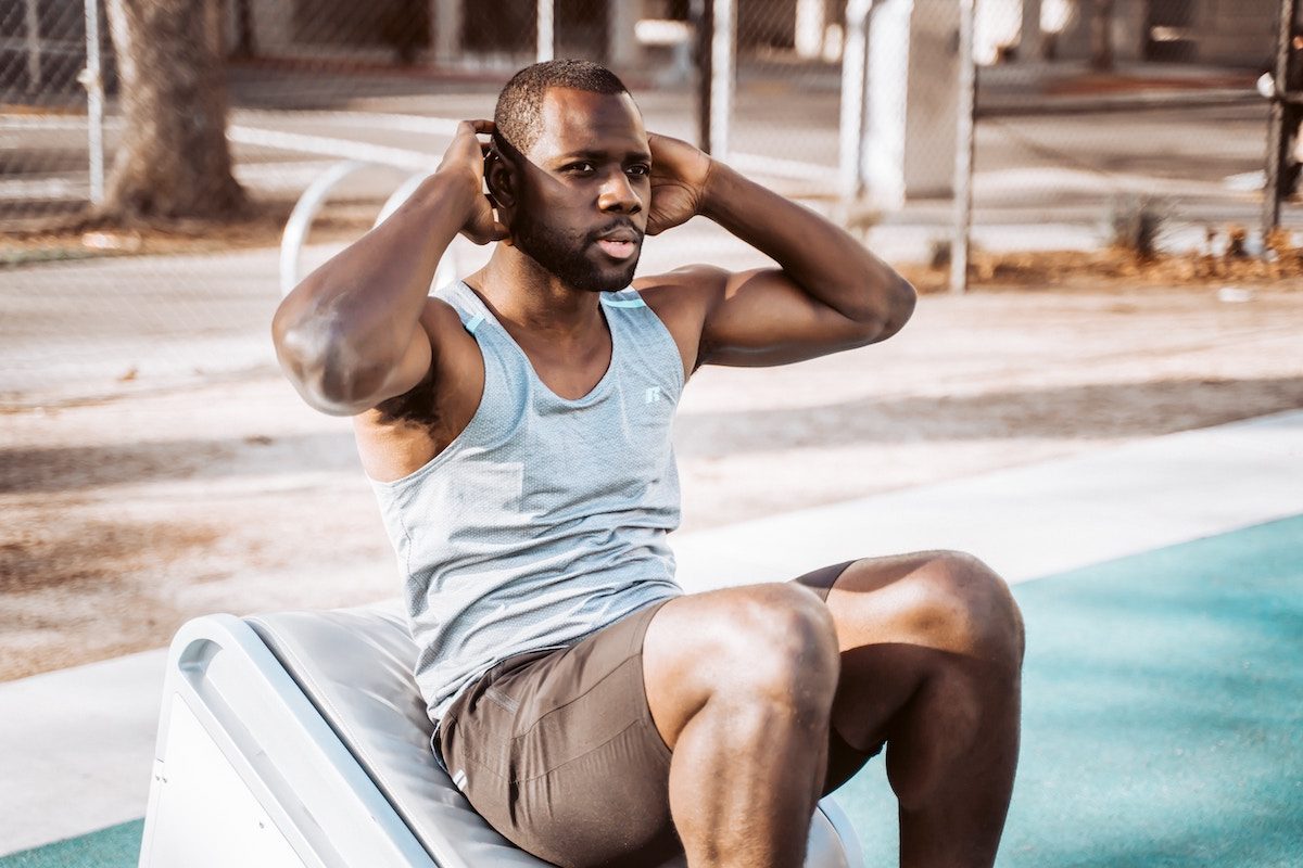 A man doing a crunch by a pool