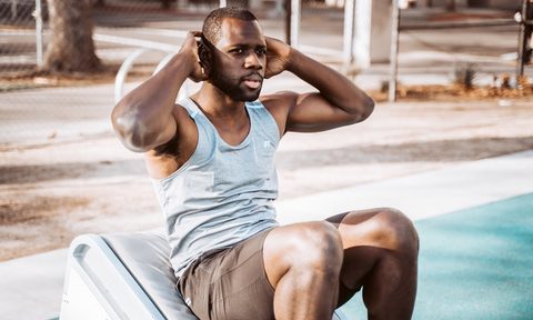 A man doing a crunch by a pool