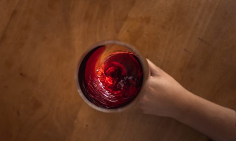 Red wine swirling in glass