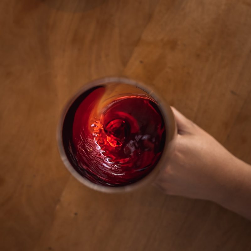 Red wine swirling in glass