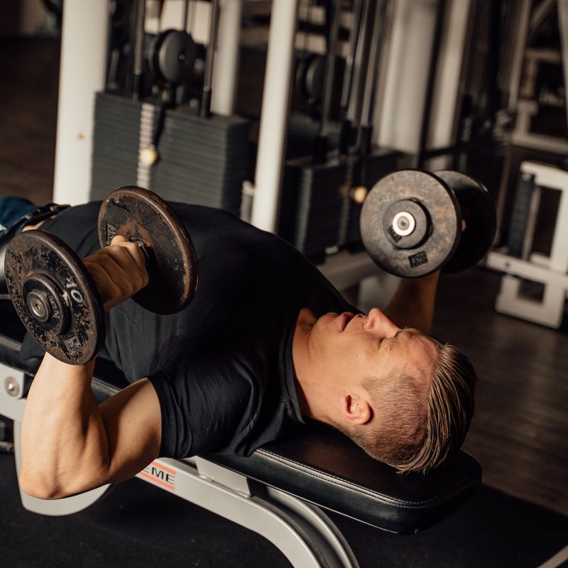 Man doing dumbbell chest press