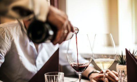 Wine being poured at dinner table