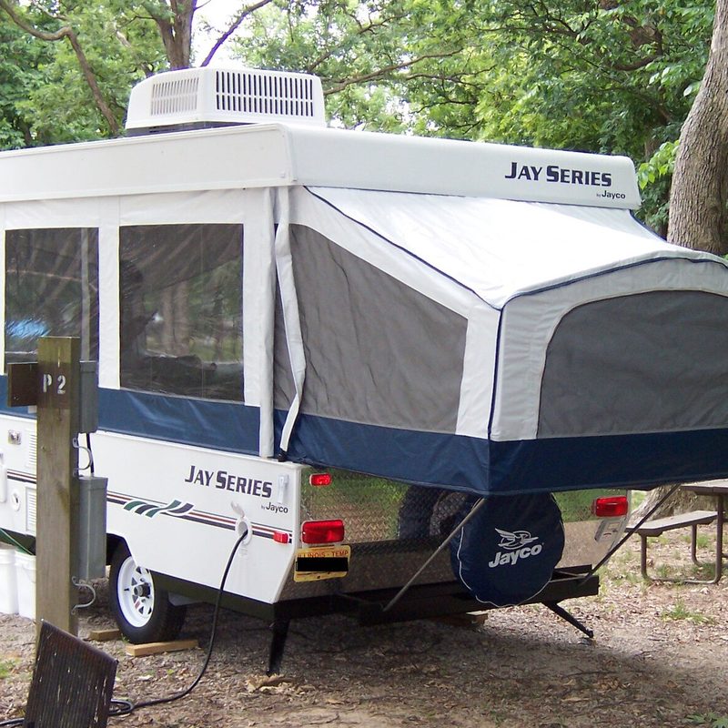 A pop-up trailer in the middle of the woods