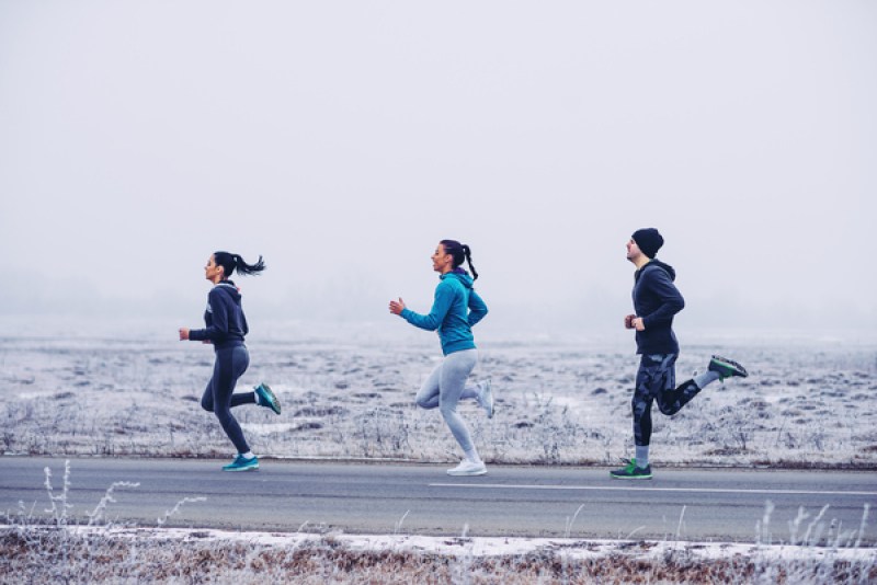 Three people running in a line