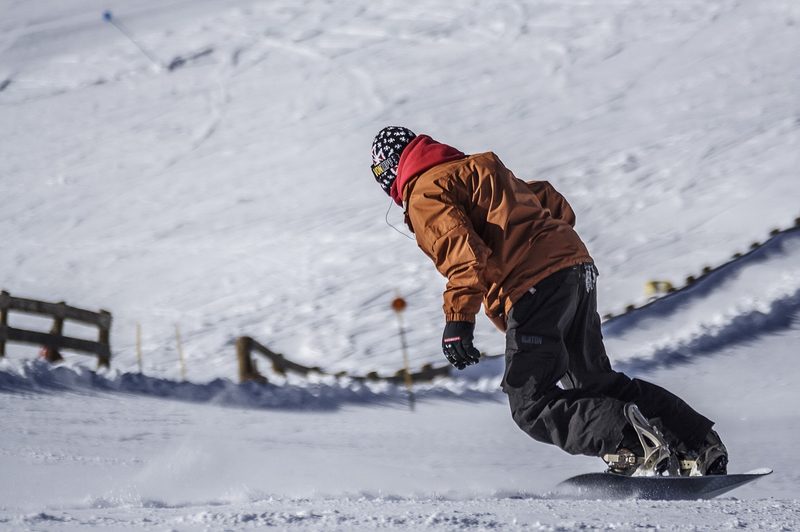 snowboarder making turns on mountain