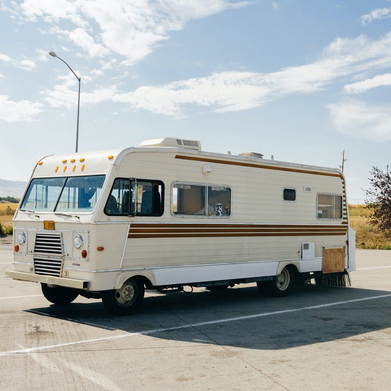 Retro Class A RV in a parking lot on a sunny day