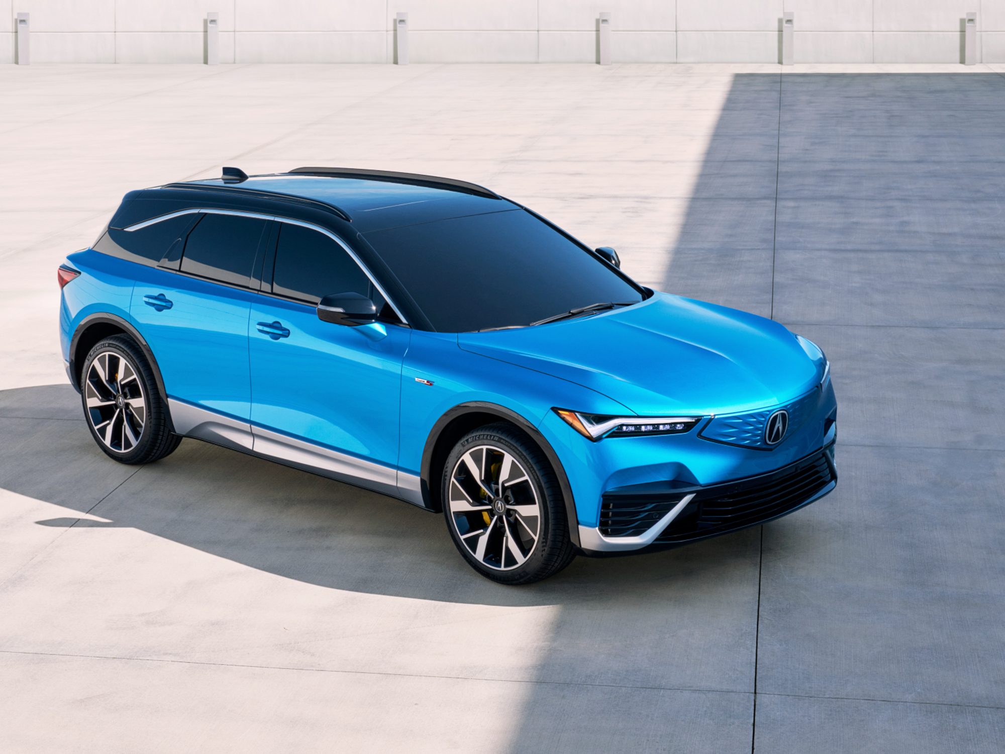 2024 Acura ZDX Type S blue with a black roof shot from high right three-quarter view.