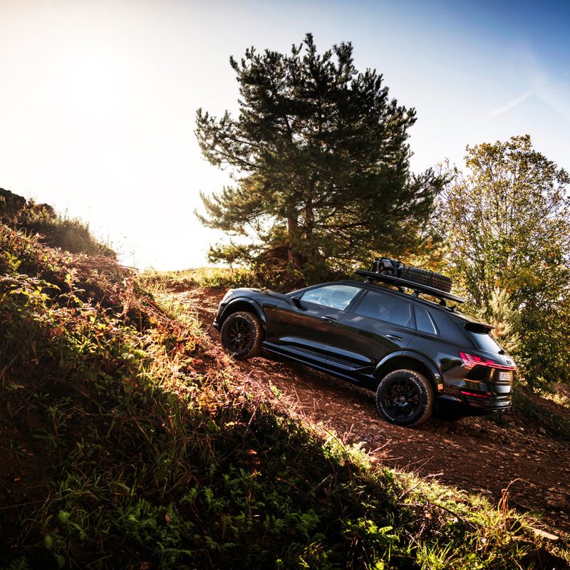 2024 Audi Q8 e-tron edition Dakar climbing a rough off-road rise