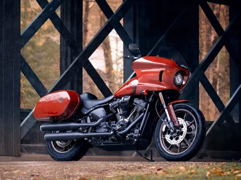 2024 Harley-Davidson Low Rider ST parked on grass under the support structures of an elevated roadway or bridge.