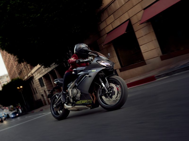 2024 Triumph Daytona 660 driving on city streets viewed from the right front.