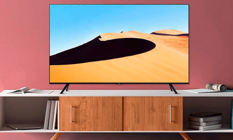 The Samsung TU690T 4K TV on a TV rack.