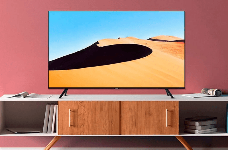 The Samsung TU690T 4K TV on a TV rack.
