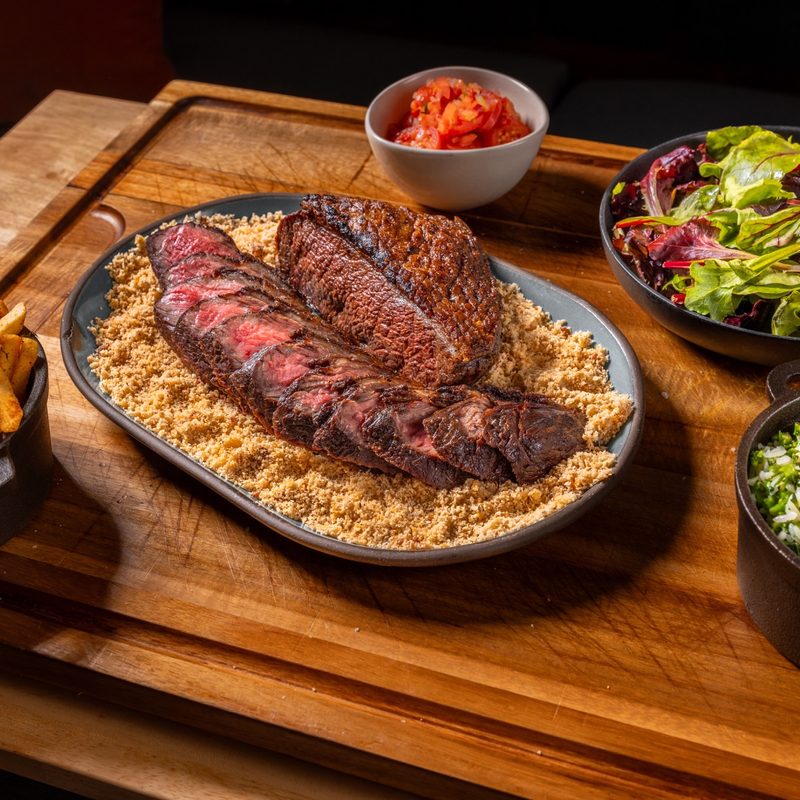 Brazilian picanha on plate with sides.