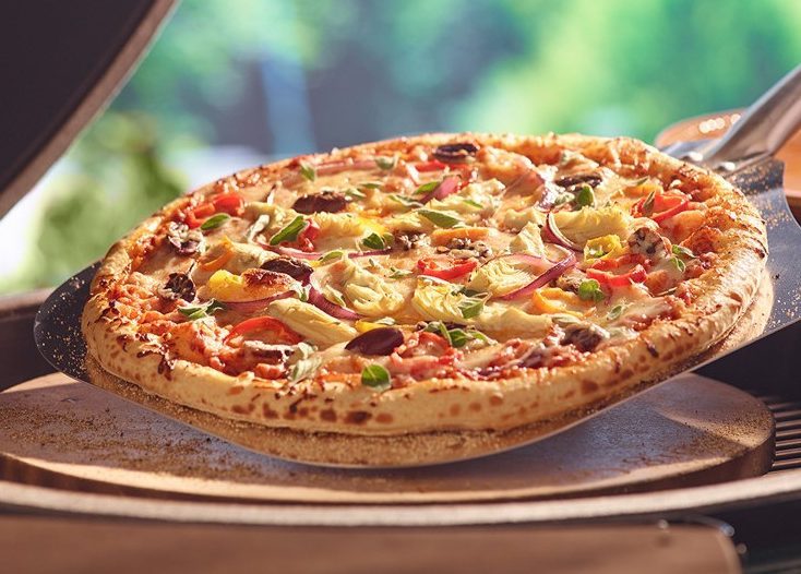 Big Green Egg accessories, pizza and baking stone in use