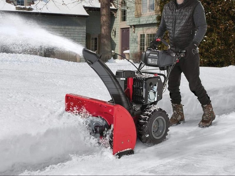 A Craftsman 357cc snow blower plows through rough terrain.