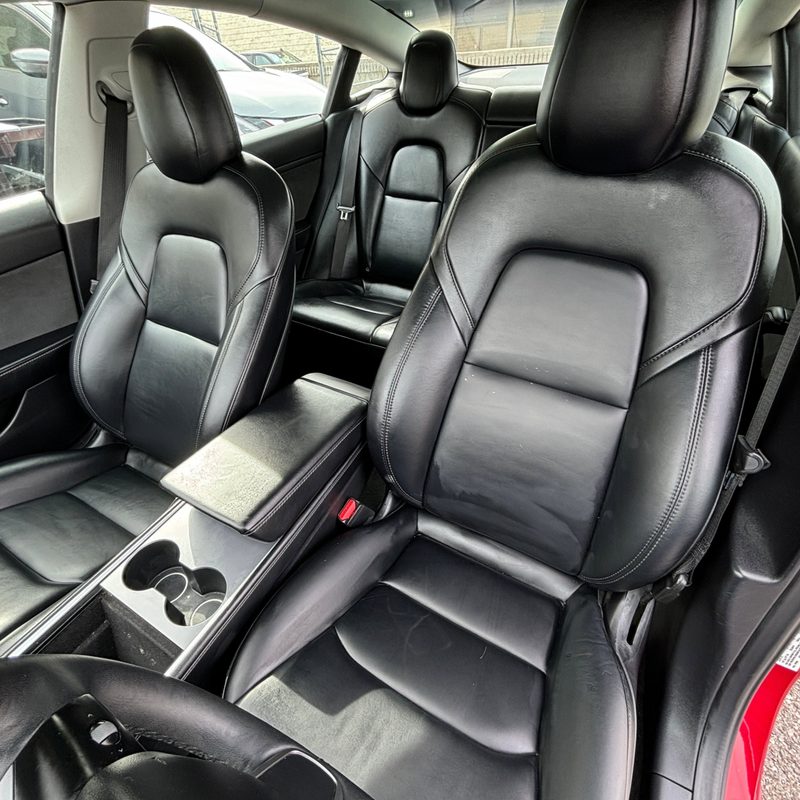 For sale by Hertz 2022 Certified Pre Owned 2022 Tesla Model 3 Long Range sedan dark interior seating.