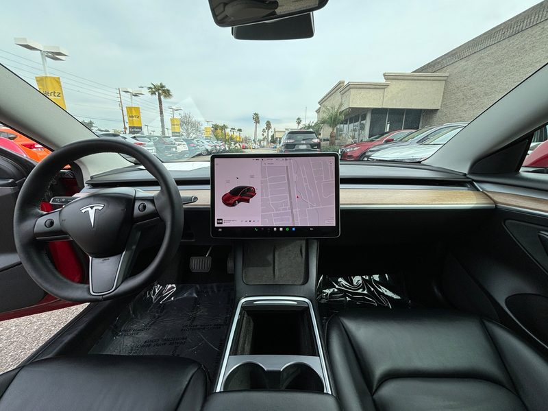 For sale by Hertz 2022 Certified Pre Owned 2022 Tesla Model 3 Long Range sedan interior with navigation system display.