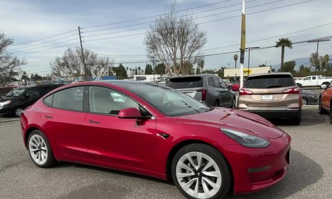 For sale by Hertz 2022 Certified Pre Owned 2022 Tesla Model 3 Long Range sedan red right front side view.