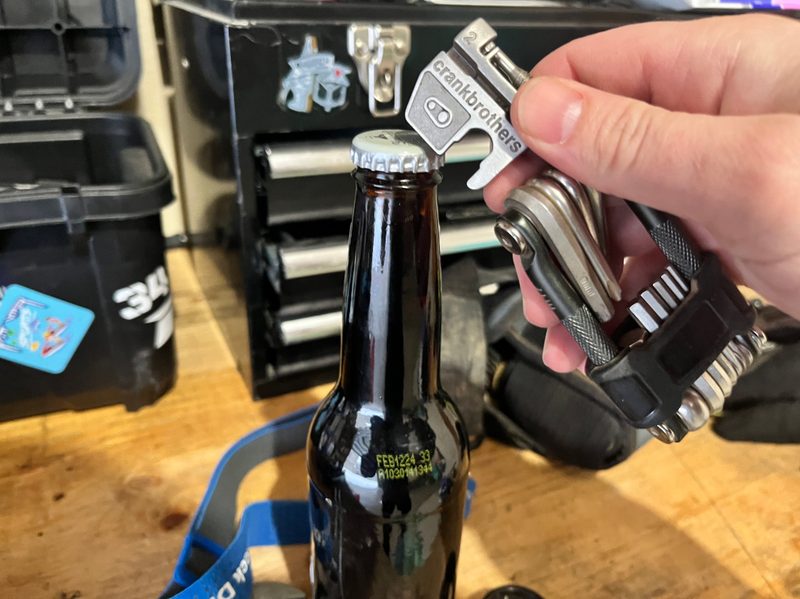 Using a mountain bike multi-tool to open a beer