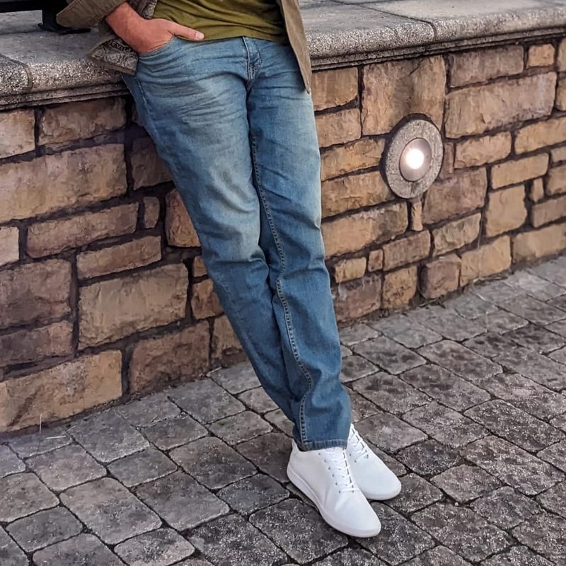 Man in jeans on bridge