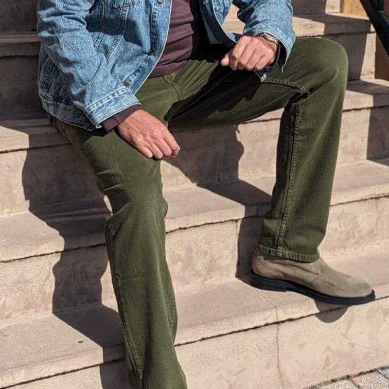 Man sitting on steps in jeans and chukkas
